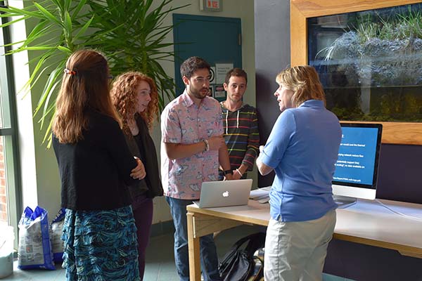 Zdenka and students standing in discussion.