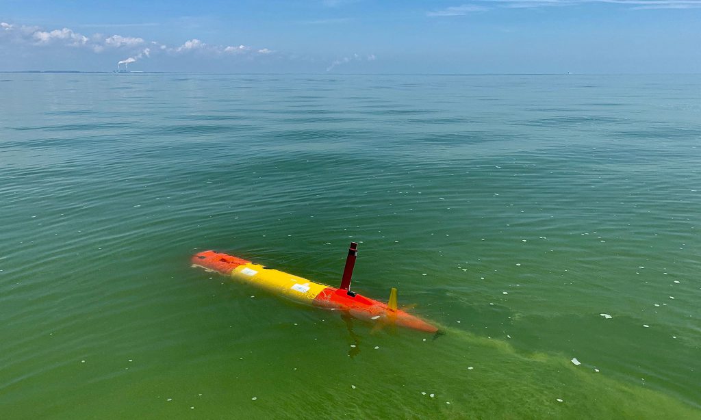 One of Monterey Bay Aquarium Research Institute's (MBARI) long-range autonomous underwater vehicles (LRAUV) makes its way through the green, algae-rich waters of Lake Erie to track the 2019 harmful algal bloom as part of a research collaboration with NOAA. Credit: Ben Yair Raanan, Monterey Bay Aquarium Research Institute (MBARI)