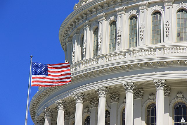 close up of U.S. Capitol dome with flag flying out front